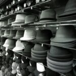 Aesthetic black and white shot featuring rows of hats on shelves in a store.